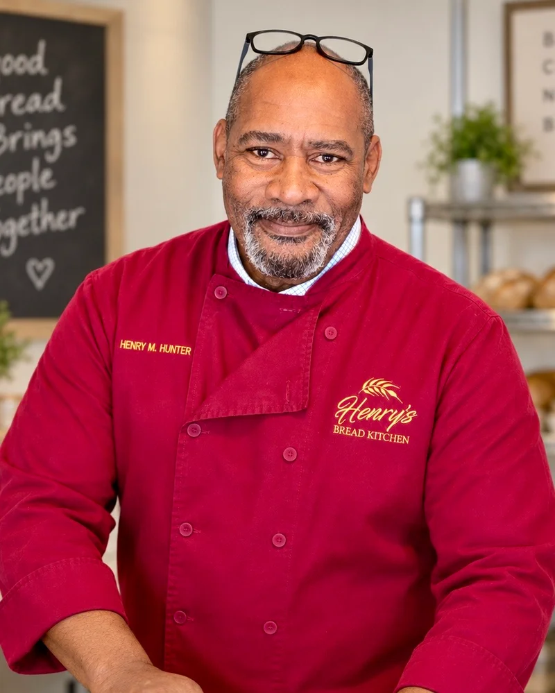 Henry Hunter in his kitchen, wearing his red chef’s coat